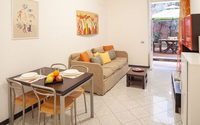 Apartment Sirene 2: Mesa, Sofá, Mueble, Propiedad, Marco, Comodidad, Naranja, Diseño De Interiores, Sala, Sofá Cama