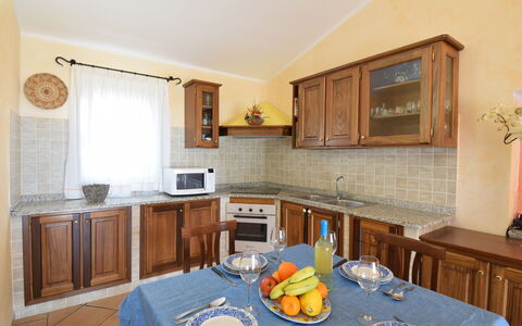 Belvedere Apartment Ac, Budoni: Mueble, Diseño De Interiores, Madera, Cocina, Gabinetes, Mostrador, Piso, Techo, Habitación, Encendiendo